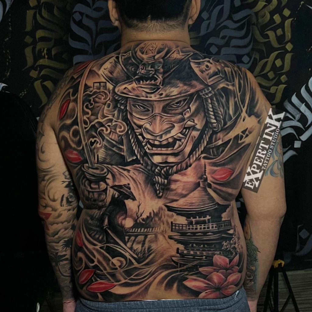 Detailed full back samurai mask tattoo in progress at Expert Ink Bali Tattoo Studio in Seminyak.